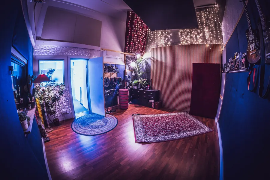 Studio live room with rugs, plants and fairy lights
