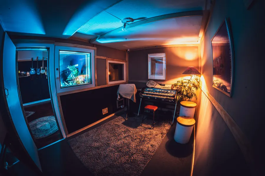 Studio lounge and control room window under blue light